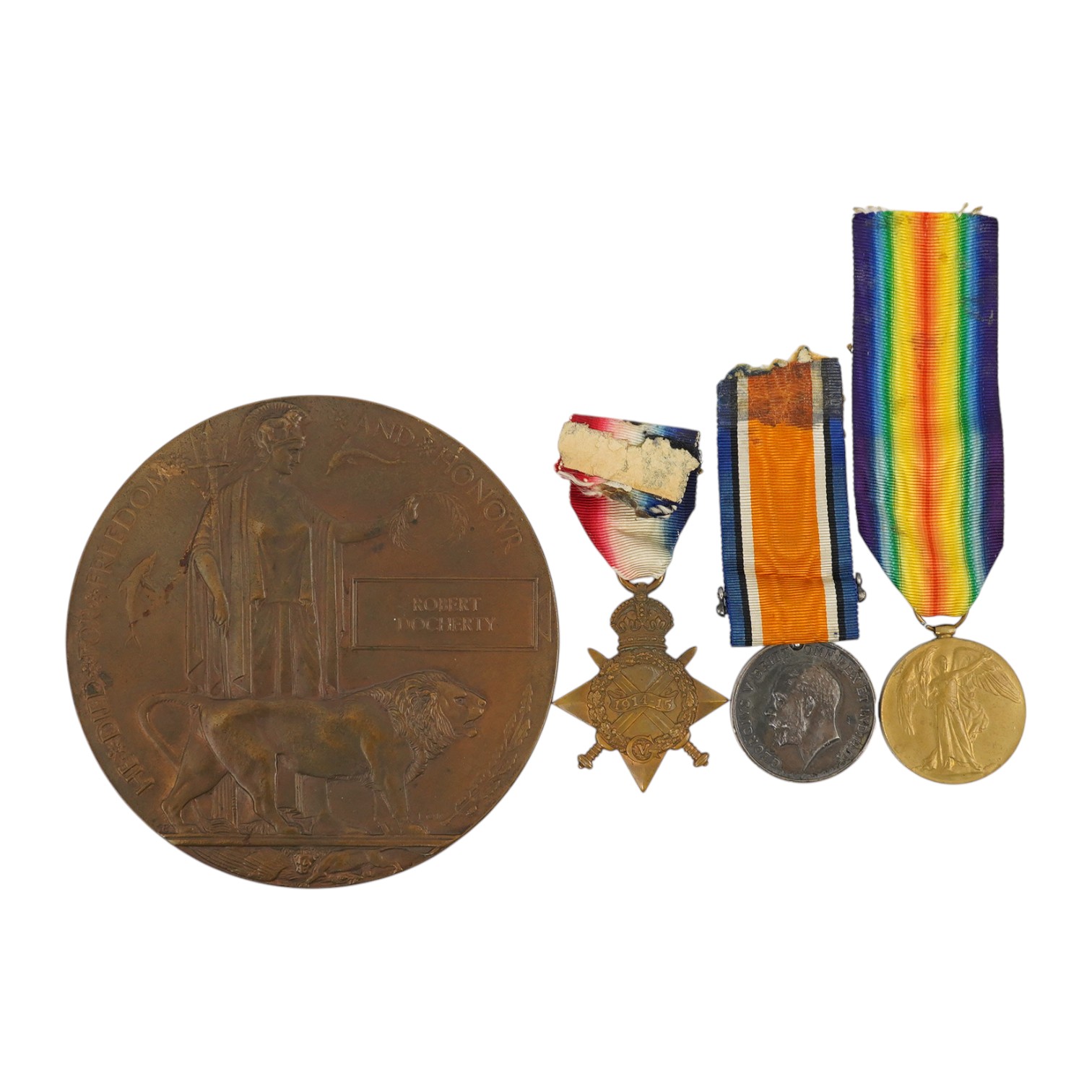 A First World War medal trio and commemorative plaque awarded to PTE. R. Docherty S. GDS. Condition fair.